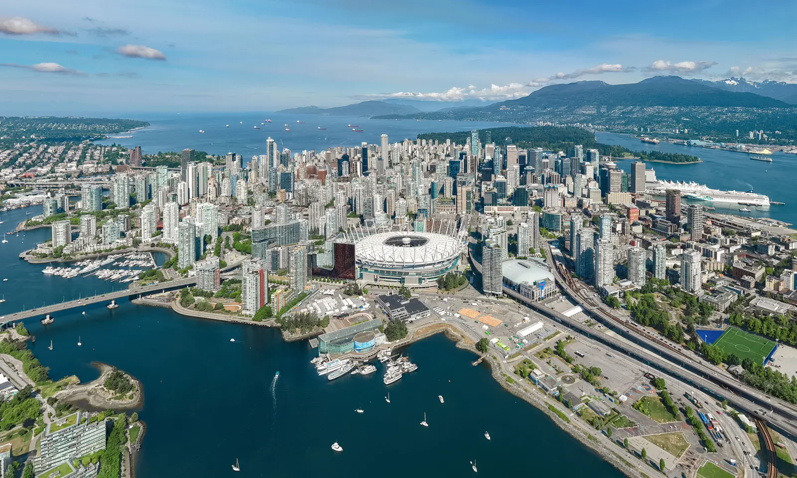 Aerial panoramic view of the Vancouver downtown peninsula, False Creek, and North Shore mountains